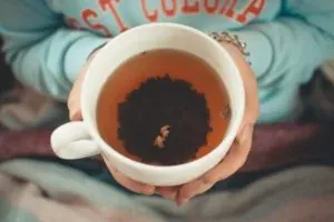 Hands holding cup of tea
