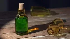 Green glass bottle on wooden table