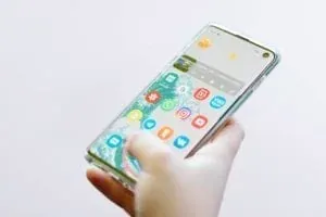 Hand holding smartphone with apps