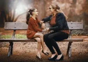 Mother and daughter on park bench