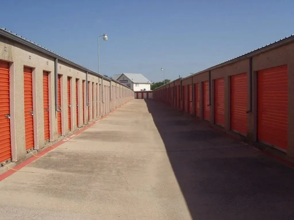 Self-storage aisle with orange roll-up doors