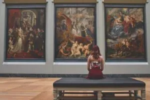 Woman viewing museum paintings