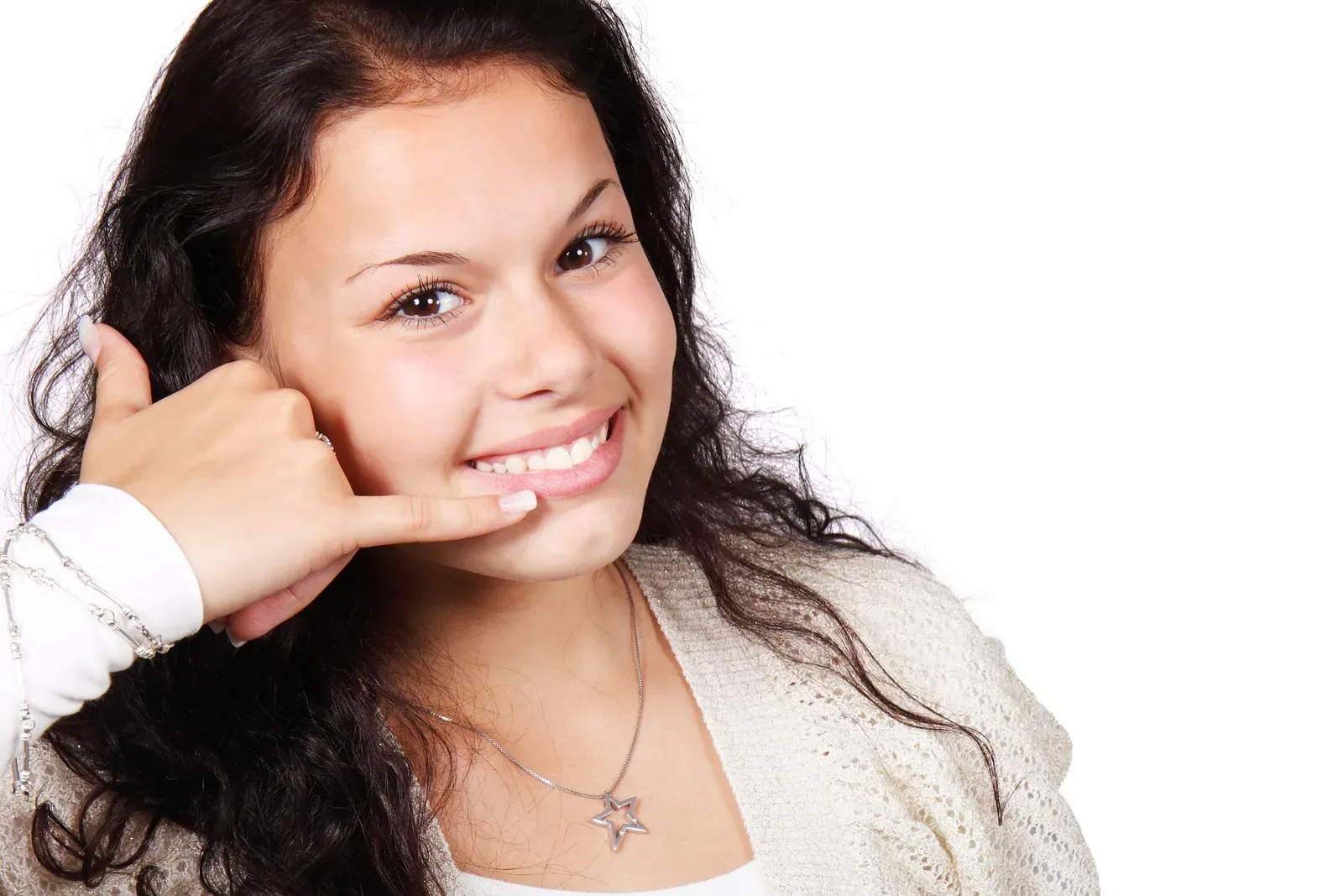Smiling young woman making call-me hand gesture