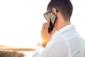 Man on phone at sunset