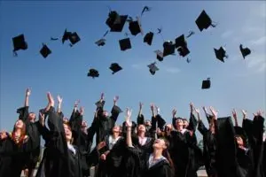 Graduates throwing caps into the sky