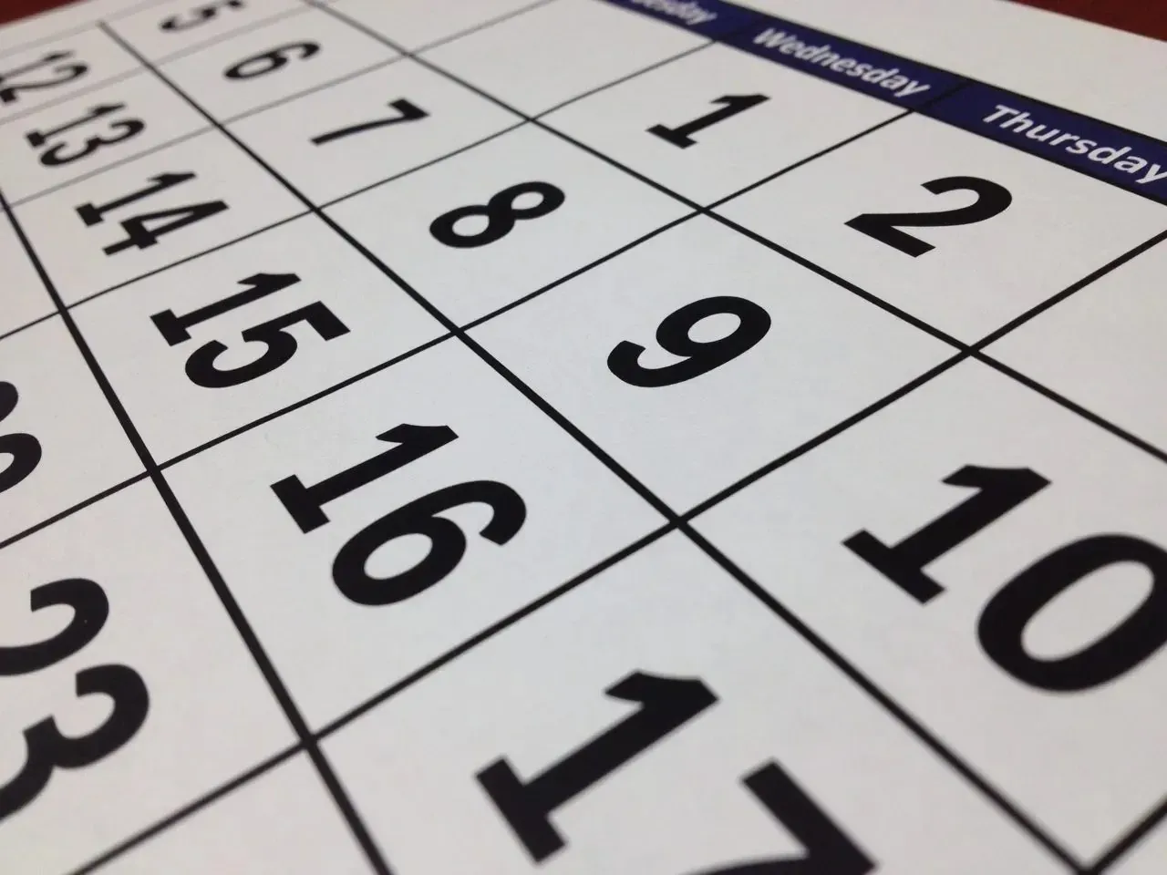 Close-up of paper wall calendar dates