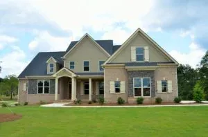 Suburban brick house with green lawn
