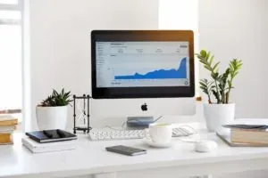 IMac with analytics chart on desk
