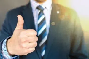 Suited man giving thumbs up