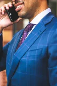 Man in blue suit on phone