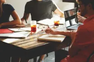 Friends around table with papers
