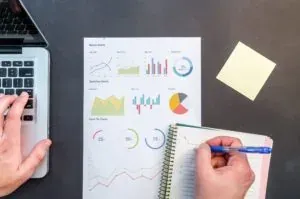 Hands with charts and notebook