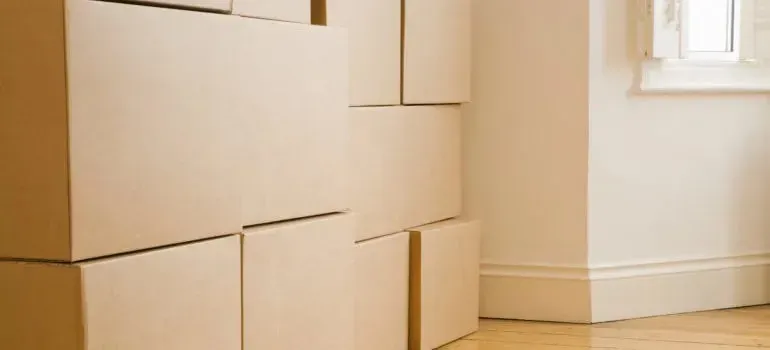 Stacked plain cardboard moving boxes in bright room