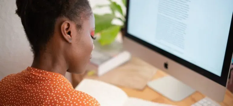 Woman working at iMac desk