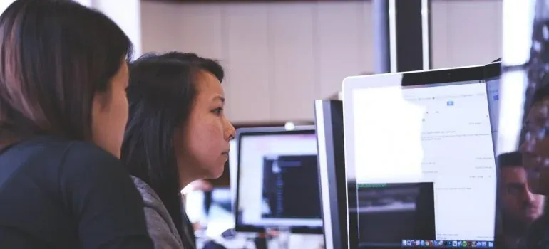 Two women looking at computer screen