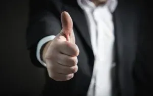 Man in suit giving thumbs up