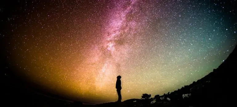 Person silhouette under starry milky way