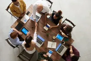 Overhead office team handshake meeting