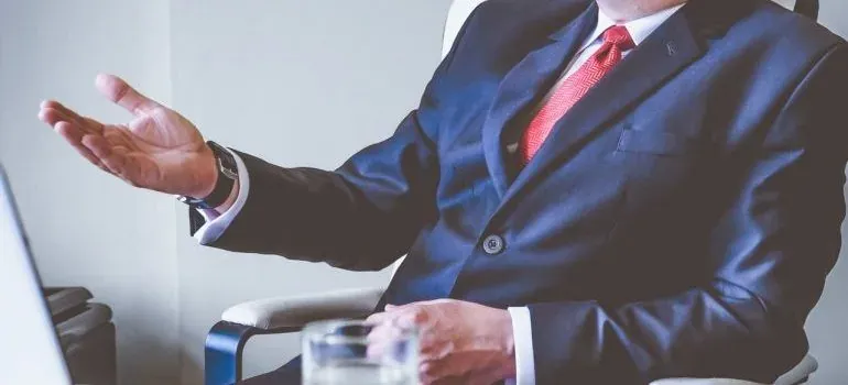 Suited man gesturing at desk