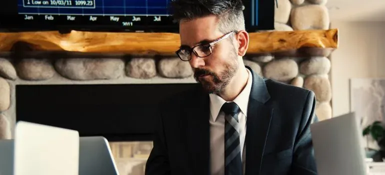 Bearded man in suit at laptop