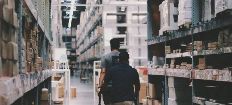 Two men in warehouse aisle