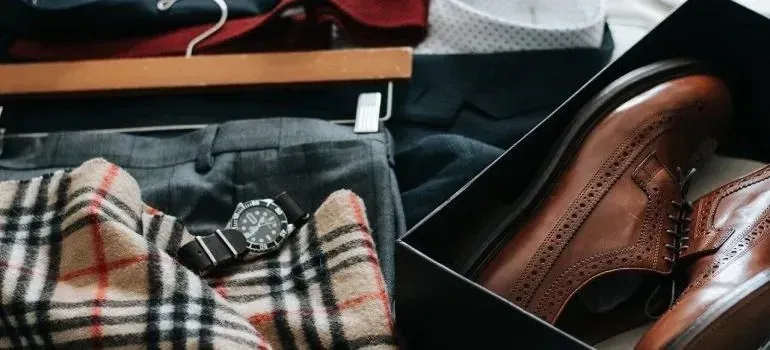 Flat lay of men's clothing, watch, and dress shoes