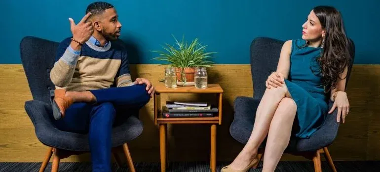 Man and woman conversing in chairs