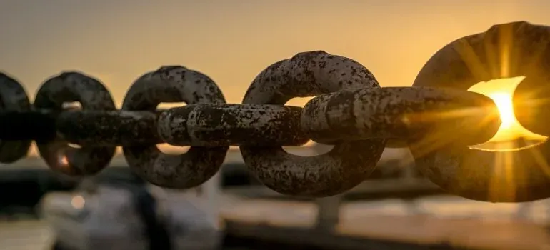 Rusty chain links at sunset