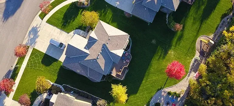 Aerial view of suburban houses with green lawns