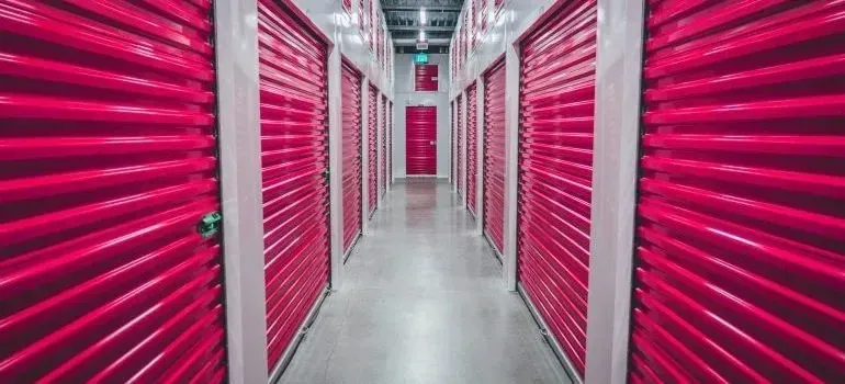Self-storage corridor of pink roll-up unit doors
