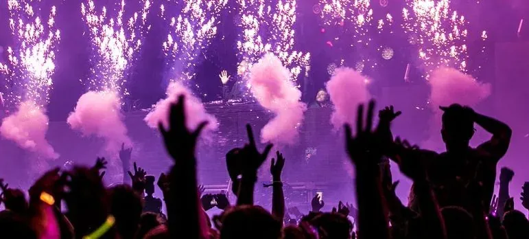 Concert crowd with purple pyrotechnics
