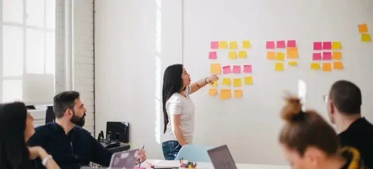 Team meeting with colorful sticky notes on whiteboard