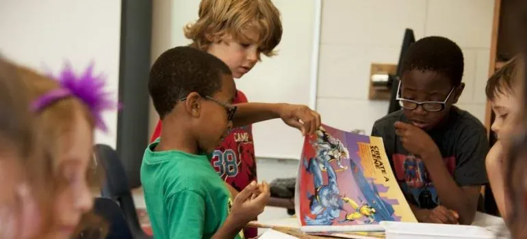 Kids reading comic poster in classroom