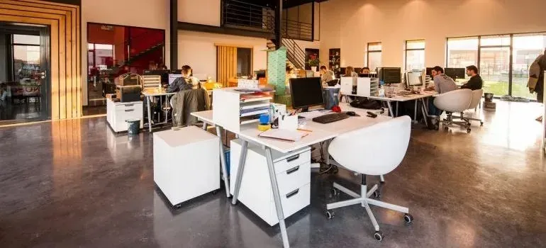 Open-plan office with employees at white desks