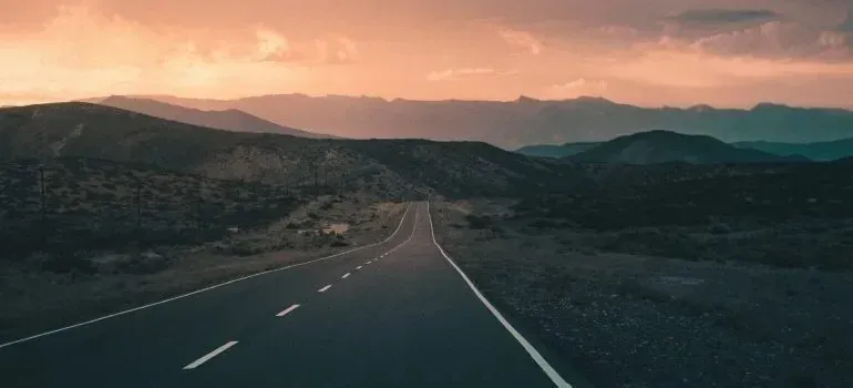 Empty highway through mountains at dusk, duplicate shot