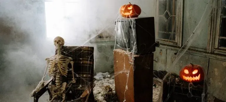 Spooky room with skeleton and pumpkins