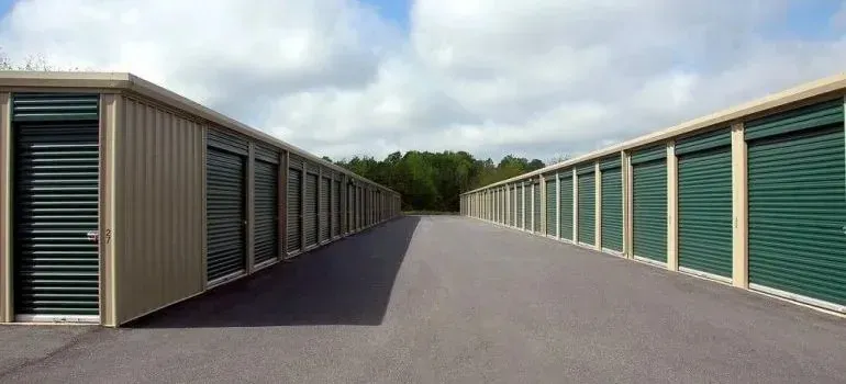 Rows of self-storage units with green roll-up doors