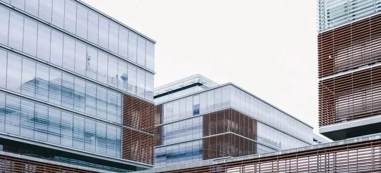 Modern glass office buildings with wooden louvers