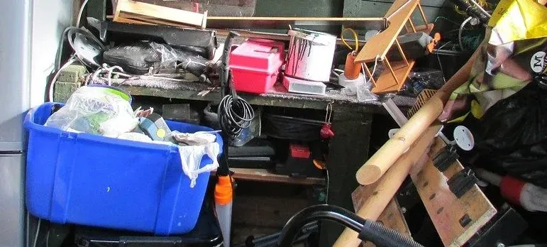 Cluttered garage workbench with tools