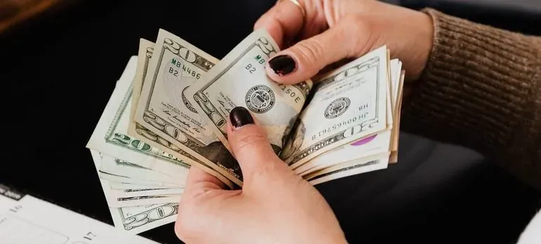 Hands counting dollar bills