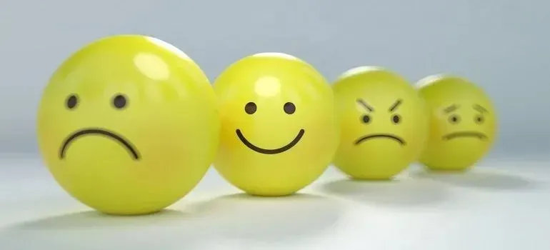 Four yellow smiley balls showing different emotions