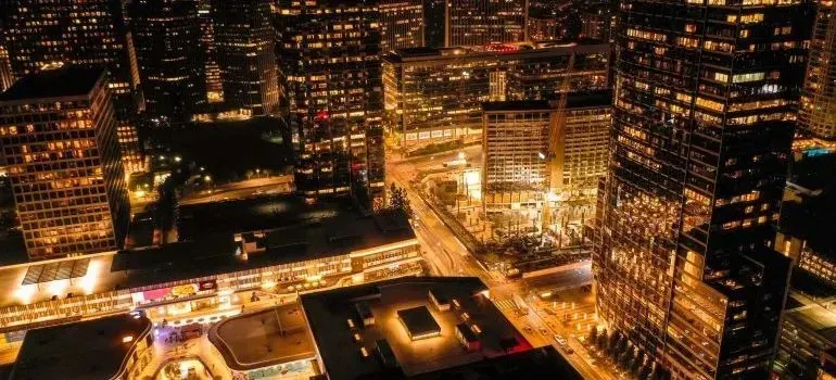 Aerial night view of illuminated city skyscrapers