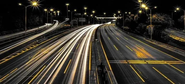 Illuminated highway at night with streaking light trails