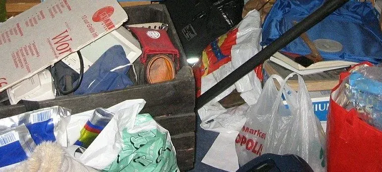 Pile of clutter, bags and crate