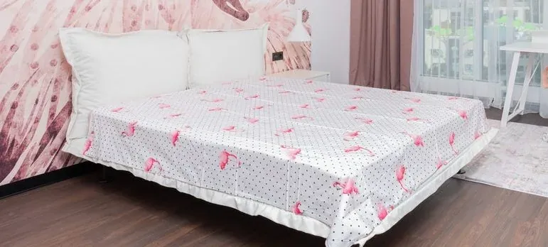 Bedroom with flamingo-print bedspread