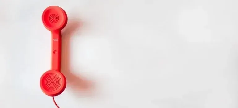 Red retro telephone handset on white background