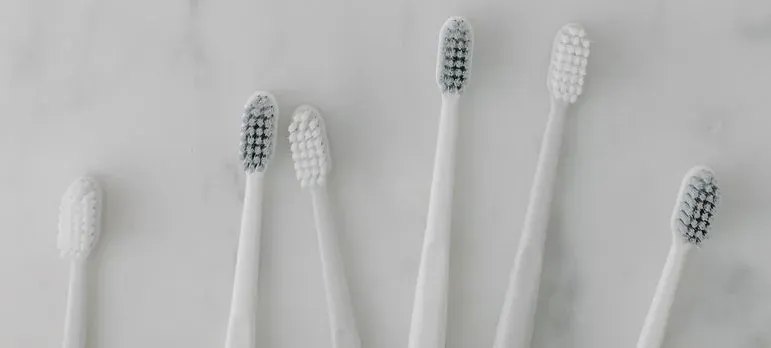 White toothbrushes on marble surface