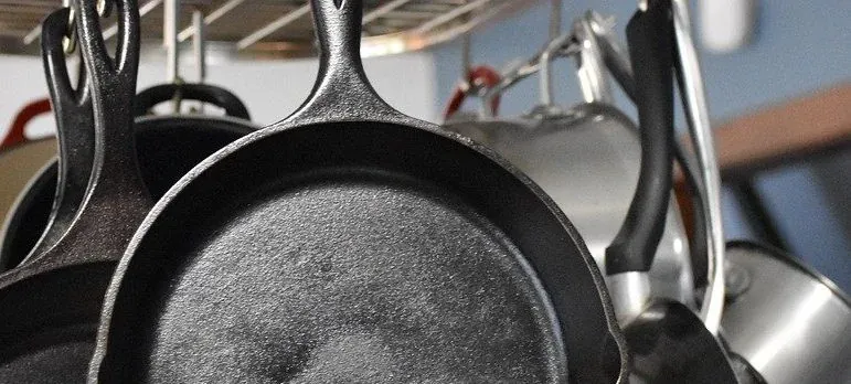 Cast iron skillets hanging in kitchen