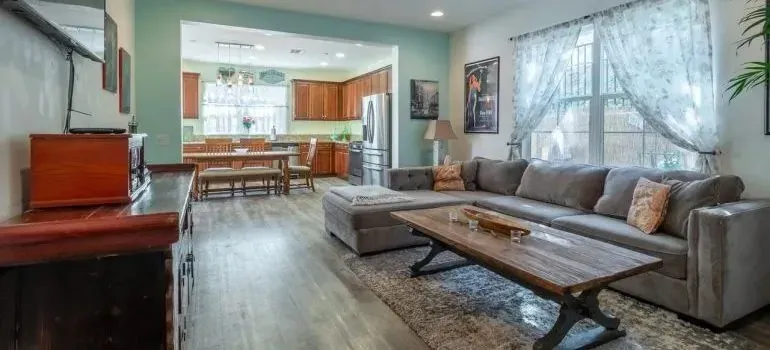 Living room interior, gray sofa, wooden coffee table