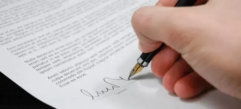 Hand signing document with fountain pen